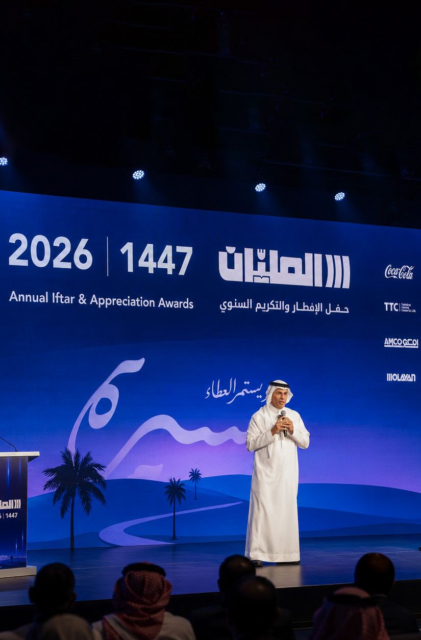 A speaker on stage beneath the 2026 / 1447 Annual Iftar and Appreciation Awards screen