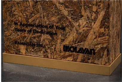 Engraved appreciation text and Olayan mark on palm wood